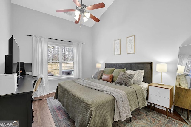 bedroom featuring ceiling fan, dark hardwood / wood-style floors, and vaulted ceiling