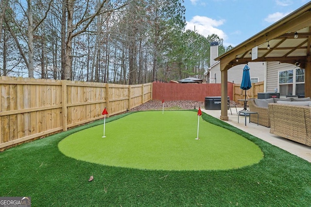 view of home's community with outdoor lounge area, a patio, and a hot tub