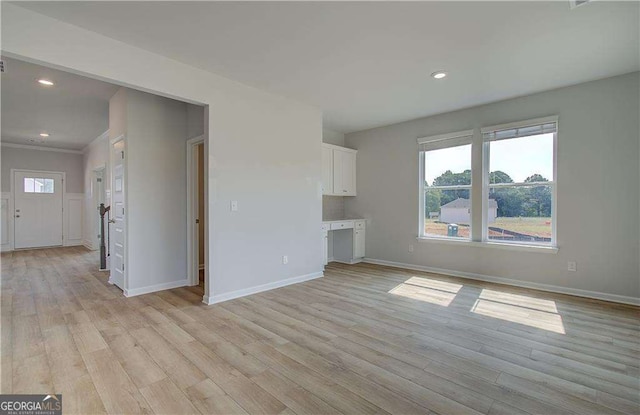 unfurnished living room with light hardwood / wood-style flooring