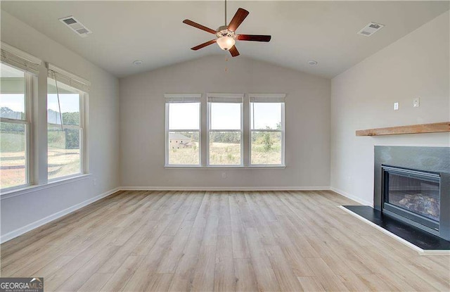 unfurnished living room with ceiling fan, lofted ceiling, and light wood-type flooring