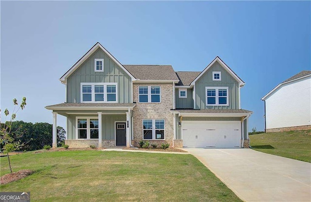 craftsman inspired home with a garage and a front yard