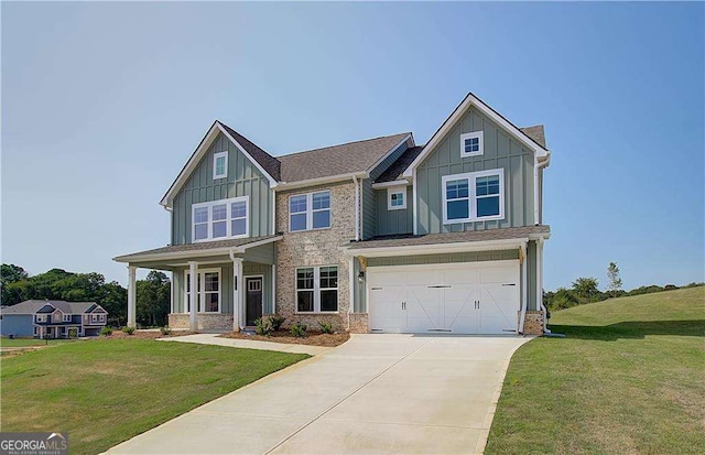 craftsman inspired home with a front yard, a porch, and a garage