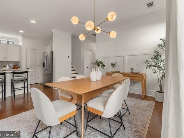 dining area with crown molding and dark hardwood / wood-style floors