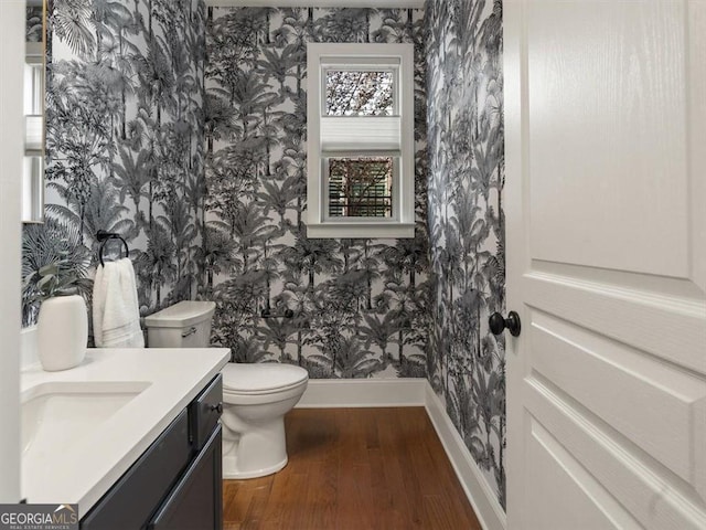 bathroom featuring vanity, hardwood / wood-style floors, and toilet