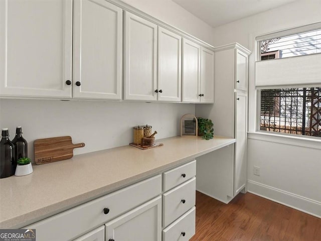 office area with plenty of natural light and hardwood / wood-style floors