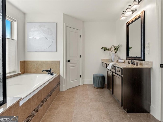 bathroom with vanity, tiled bath, and tile patterned floors