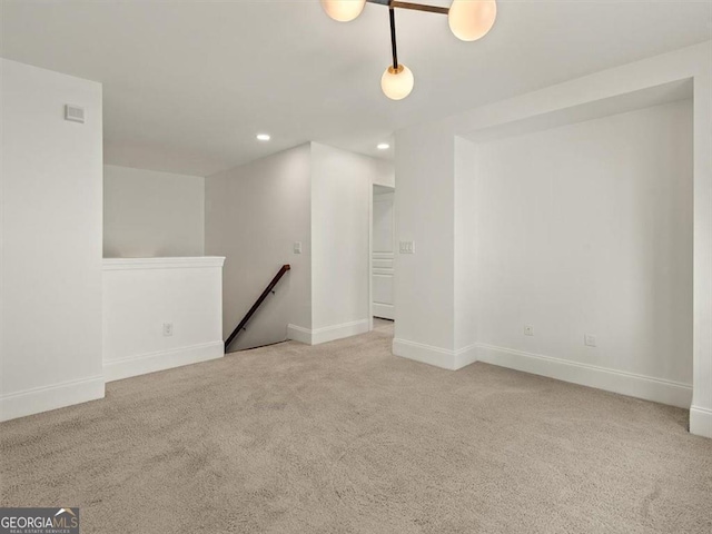 unfurnished room featuring light carpet