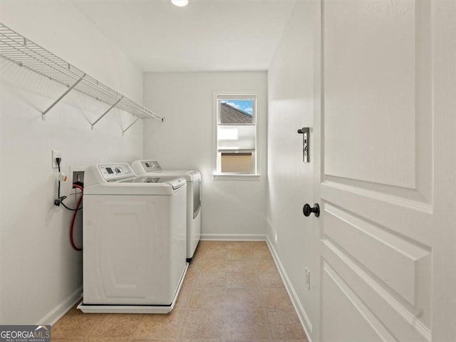 clothes washing area with washing machine and dryer