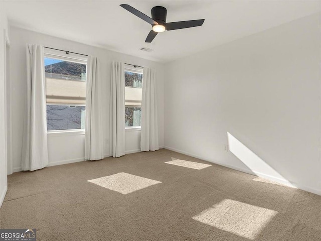 empty room with light carpet and ceiling fan