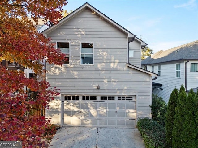 view of side of home featuring a garage