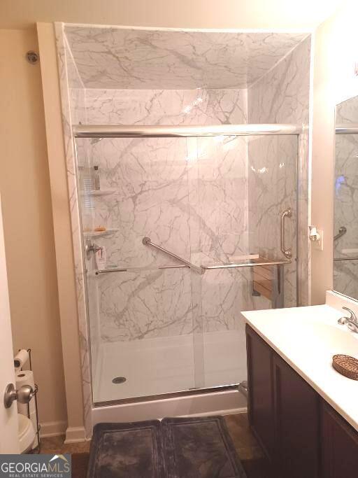 bathroom featuring vanity and an enclosed shower