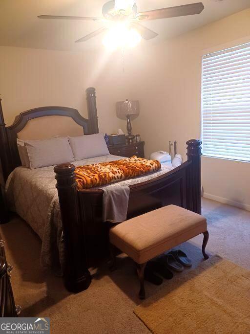 carpeted bedroom with ceiling fan