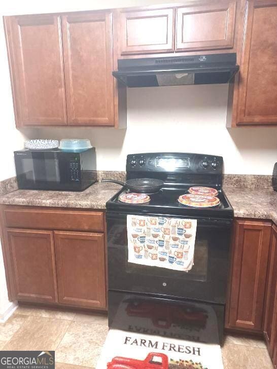 kitchen featuring ventilation hood and black appliances