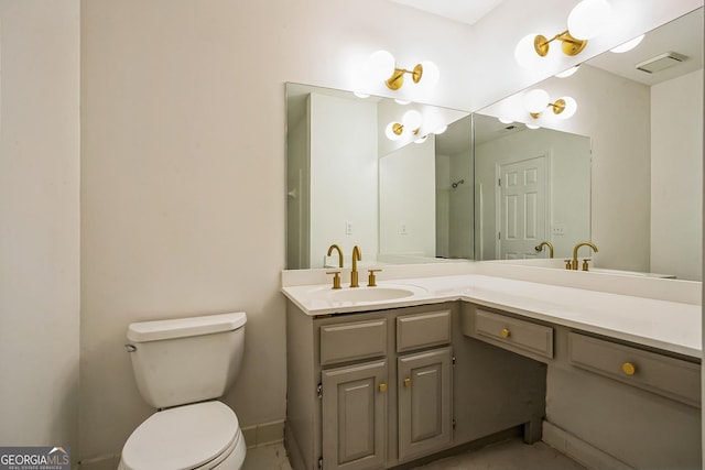 bathroom with toilet and vanity