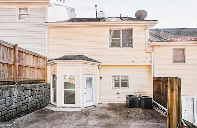 back of house with central air condition unit and a patio area