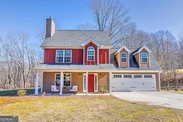 view of front facade featuring a front yard, a garage, and covered porch