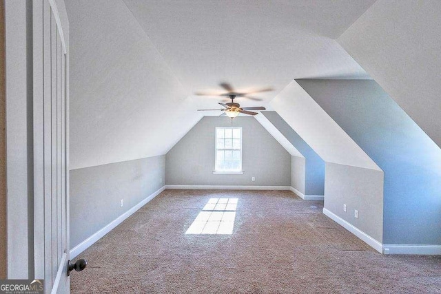 bonus room with ceiling fan, light colored carpet, and vaulted ceiling