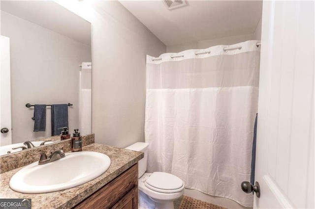 bathroom featuring vanity and toilet