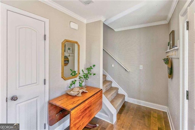 foyer with hardwood / wood-style floors and ornamental molding