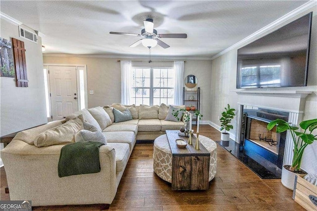 living room featuring ornamental molding, dark hardwood / wood-style flooring, and ceiling fan