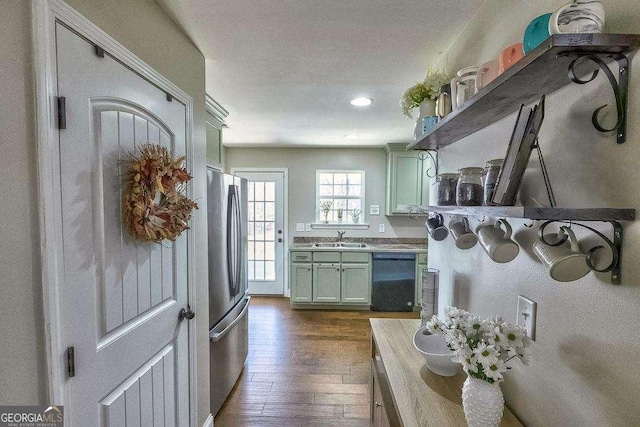 kitchen featuring stainless steel refrigerator, dishwasher, dark hardwood / wood-style floors, and sink