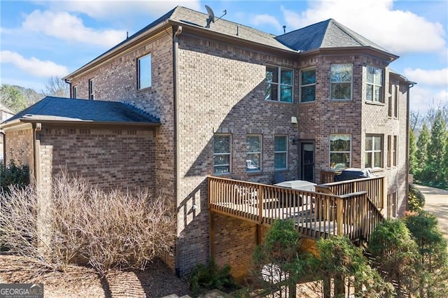 back of house featuring a wooden deck