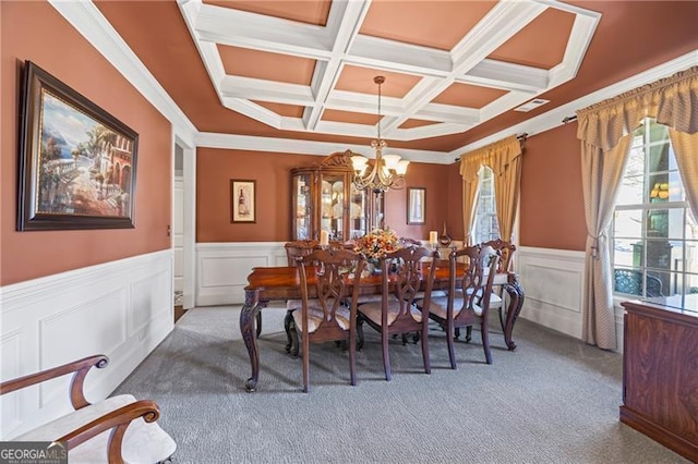 carpeted dining space with beamed ceiling, an inviting chandelier, crown molding, and coffered ceiling