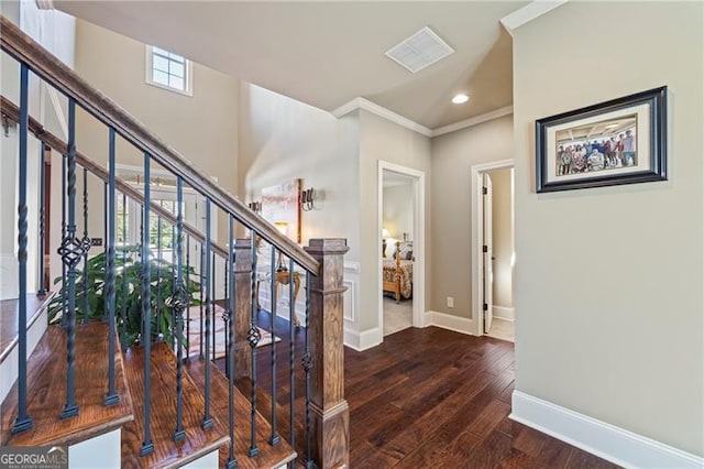 interior space with crown molding, plenty of natural light, and hardwood / wood-style floors