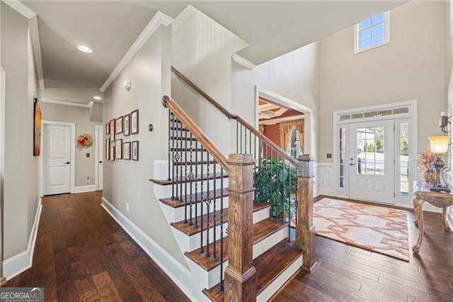 foyer with dark hardwood / wood-style flooring and crown molding