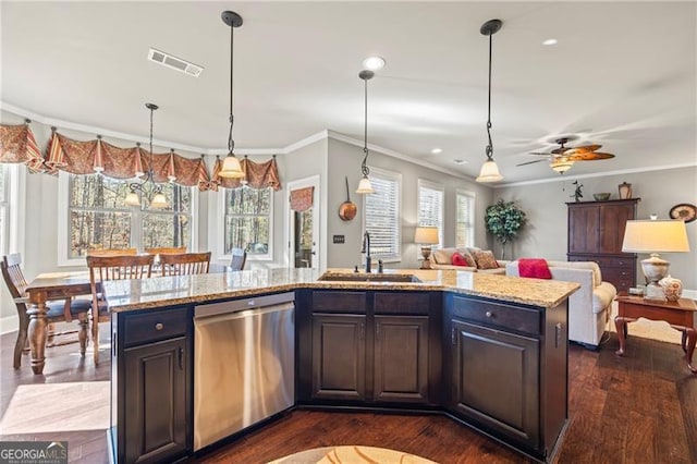 kitchen with stainless steel dishwasher, dark brown cabinetry, crown molding, sink, and a center island with sink