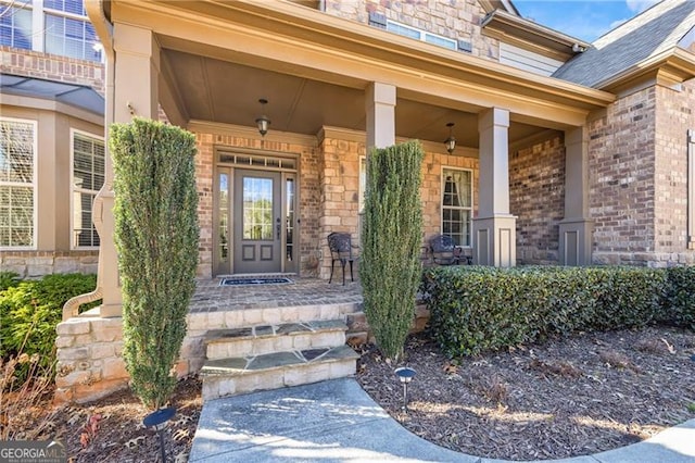 view of exterior entry with a porch