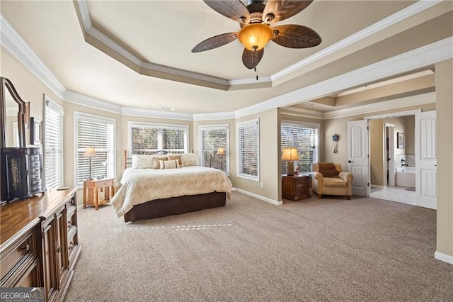 carpeted bedroom with a tray ceiling, ceiling fan, and crown molding