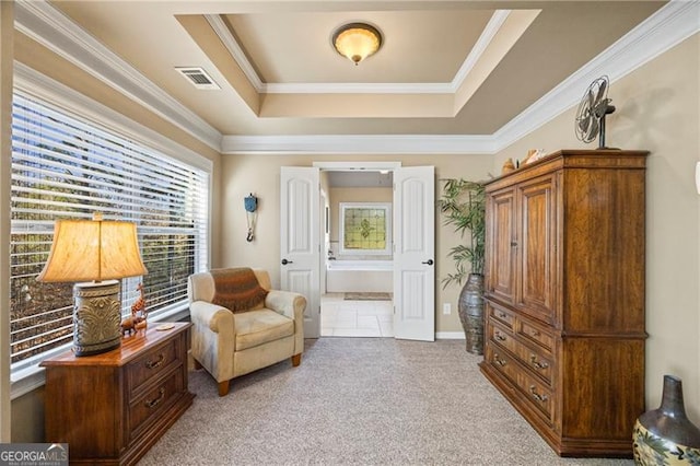 sitting room with light carpet, a raised ceiling, and crown molding