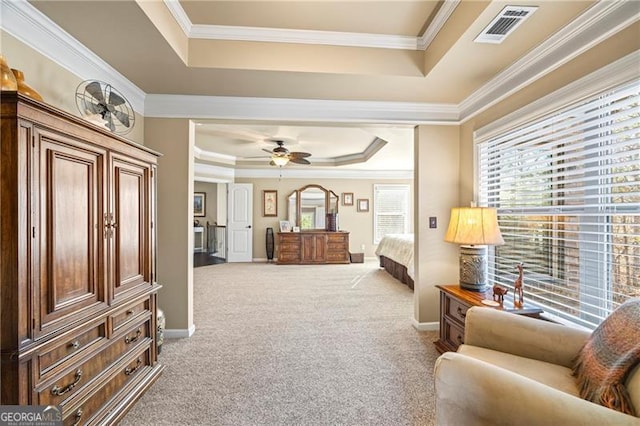 living area with carpet flooring, a tray ceiling, ceiling fan, and crown molding