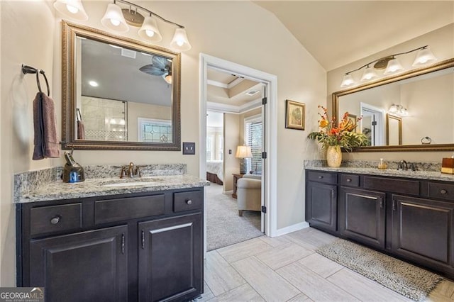 bathroom featuring vanity, lofted ceiling, and crown molding