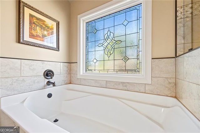 bathroom with tiled tub