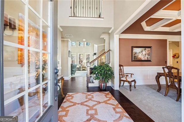 foyer featuring dark wood-type flooring and ornamental molding