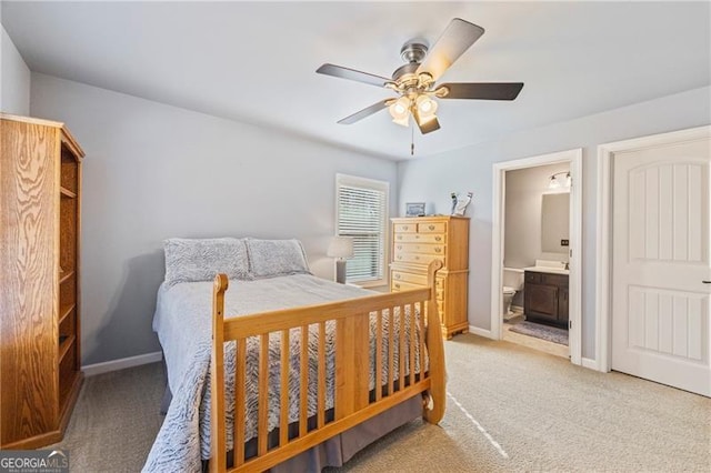 bedroom featuring carpet flooring, ensuite bath, and ceiling fan