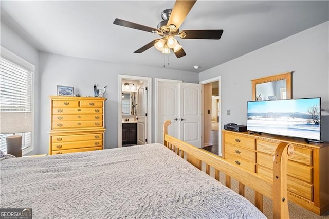 bedroom featuring connected bathroom and ceiling fan