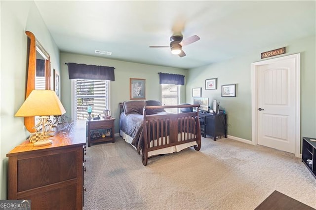 bedroom with ceiling fan, carpet floors, and multiple windows