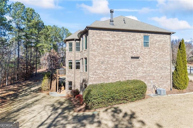 view of side of property with central AC