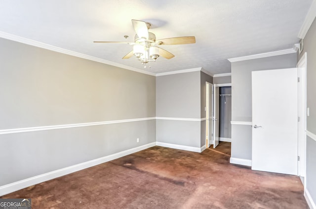 unfurnished bedroom featuring dark colored carpet, ceiling fan, ornamental molding, and a closet