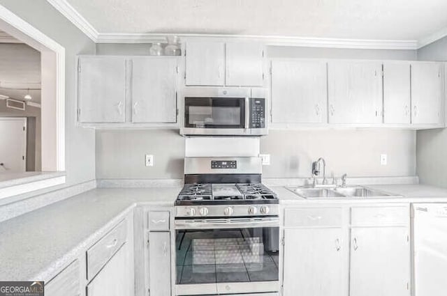 kitchen with white cabinetry, sink, stainless steel appliances, and ornamental molding