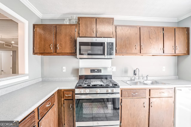 kitchen featuring appliances with stainless steel finishes, a textured ceiling, crown molding, and sink