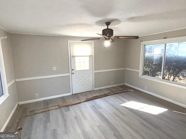 unfurnished room with hardwood / wood-style flooring, ceiling fan, and a textured ceiling