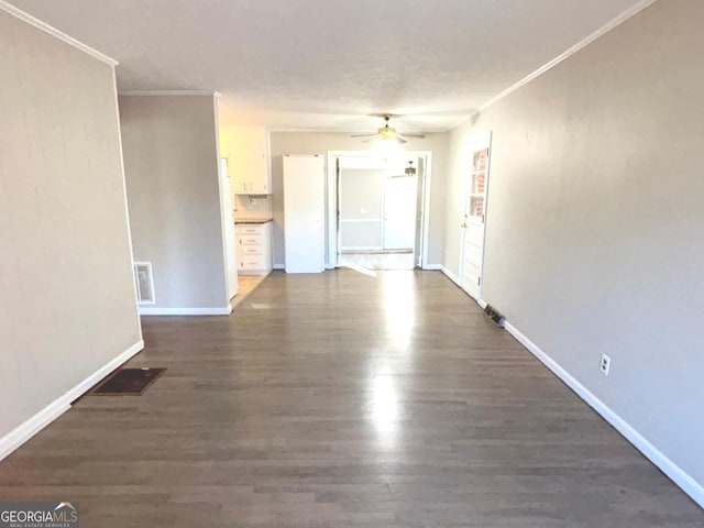 unfurnished room with ceiling fan, dark hardwood / wood-style flooring, and ornamental molding