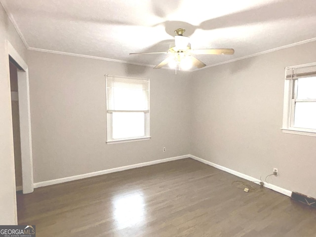 unfurnished room with a textured ceiling, ceiling fan, ornamental molding, and dark wood-type flooring