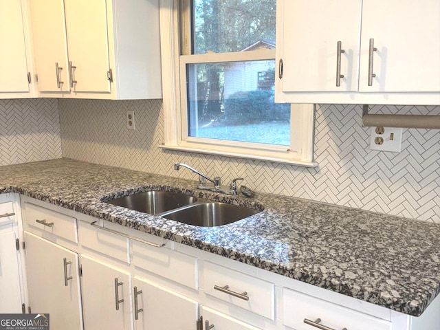 kitchen with decorative backsplash, white cabinetry, plenty of natural light, and sink