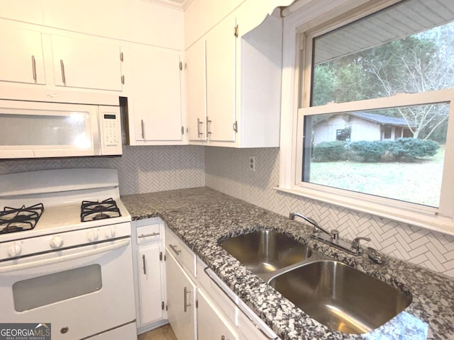 kitchen featuring white cabinetry, decorative backsplash, and white appliances