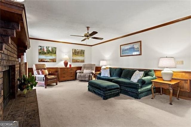 living room featuring ceiling fan, crown molding, carpet, and a brick fireplace